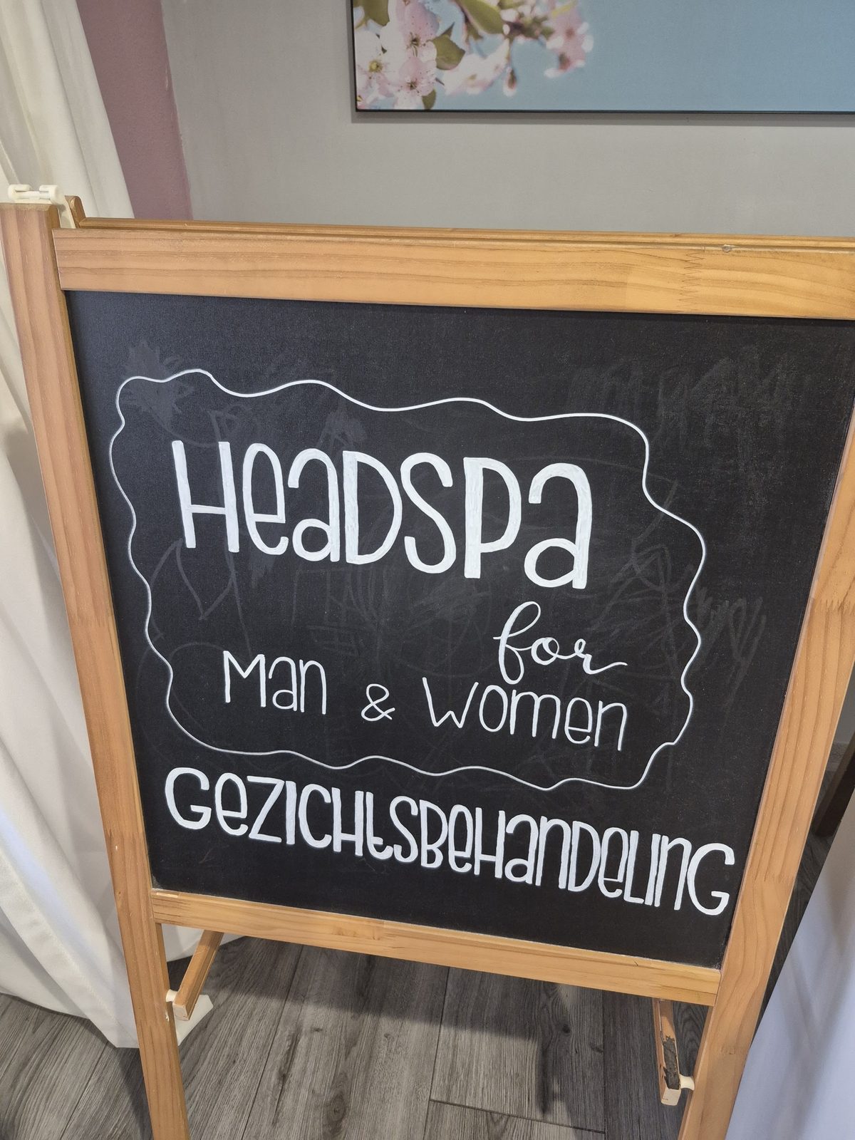 Krijtbord met de tekst Headspa for Man & Women en Gezichtsbehandeling